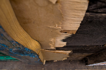 An ancient background in the form of a wooden texture with a shabby weathered paint of different colors. Vintage coating on boards of different sizes. Broken sharp wood.