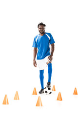 full length view of young african american sportsman standing with soccer ball and smiling at camera isolated on white