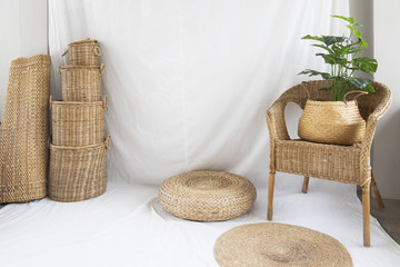 Background and texture of wicker chair and basket weave on white fabric. Decorations with tree.
