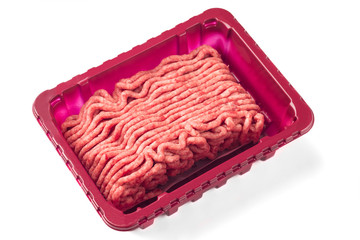 Raw mincemeat in the plastic box on white