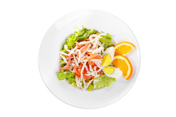 Salad with seafood with squid, tomato, bell pepper, fish, salmon, lettuce, boiled egg and orange, citrus on plate, white isolated background, view from above, for the menu, restaurant, bar cafe