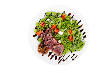 Salad with roast beef with marinated onions and balsamic vinegar, sauce on plate, white isolated background, view from above, for the menu, restaurant, bar, cafe