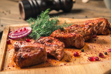 meat shish kebab with spices on a wooden board