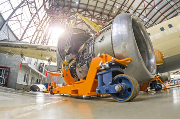 The engine of the aircraft is repaired, removed from the wing and installed on a technical cart.