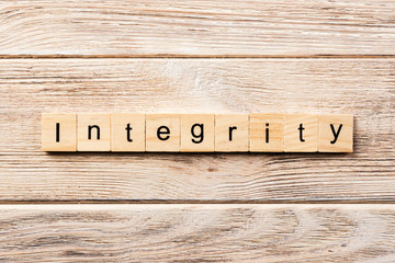 integrity word written on wood block. integrity text on table, concept