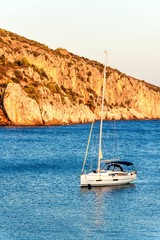 Sailboats moored at the rocky coast of Croatia. Evening bay on the island of Hvar. Relax in the sea. Ships at sunset. Holidays on a sailboat.