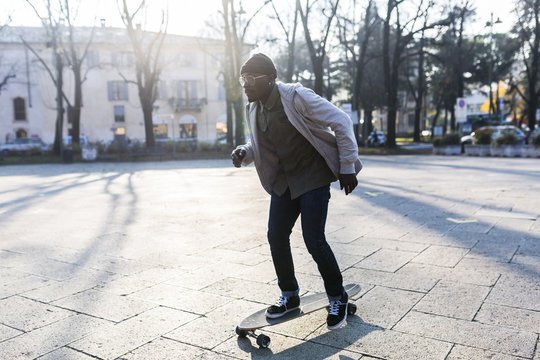 Young man skateboarding on an urban square