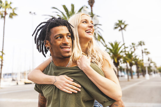 Spain, Barcelona, portrait of multicultural young couple on promenade