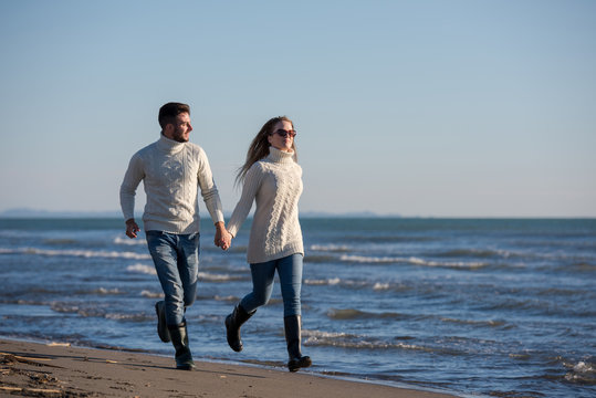 Loving young couple on a beach at autumn sunny day