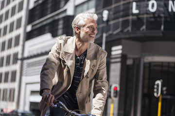 Mature man riding bicycle in the city