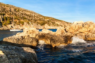 Sailboats moored at the rocky coast of Croatia. Evening bay on the island of Hvar. Relax in the...