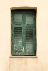 Fototapeta na wymiar Old wooden window with green shutters.