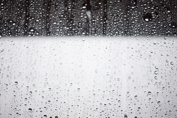 Window view blurry with heavy rain, natural raindrops on glass