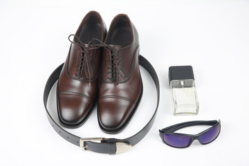 Fototapeta na wymiar Classic men's shoes, belt and glasses on white background