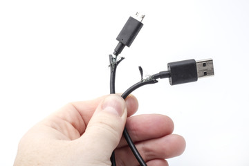 two broken usb cord in hand on a white background