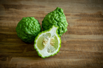 close up bergamot fruit and bergamot slice on wooden background.