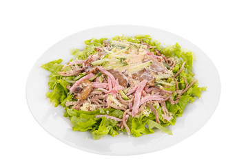 Salad with mushrooms, champignons, ham, cucumber, cheese, lettuce, mayonnaise on plate, white isolated background Side view. For the menu restaurant bar cafe