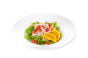 Salad with seafood with squid, tomato, bell pepper, fish, salmon, lettuce and orange, citrus on plate, white isolated background Side view. For the menu, restaurant, bar, cafe