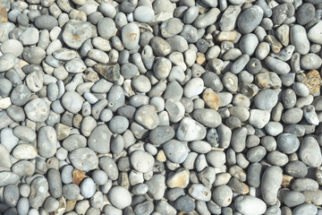 All rounded tiny pebbles from beach, a natural summer background, smooth polished pebble stones
