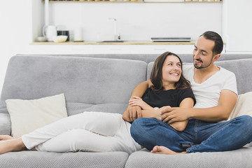 happy mature couple sitting on couch at home and relaxing togetherness.