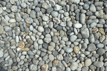 All rounded tiny pebbles from beach, a natural summer background, smooth polished pebble stones