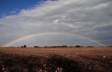 Wide rainbow in the open countryside / Side to side rainbow in the horizon after or before the storm / La Pampa, Argentina
