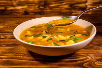 Georgian traditional food soup kharcho on wooden table