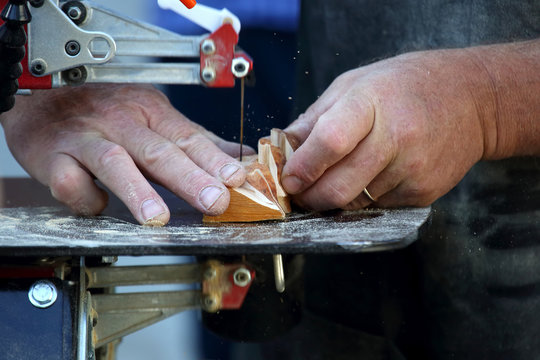 man processes a tree with an electric jigsaw close-up