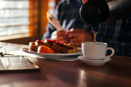 Waitress Pouring Fresh Coffee At A Classic Breakfast Diner