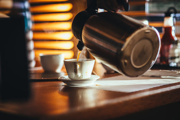 Waitress Pouring Fresh Coffee At A Classic Breakfast Diner