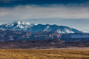 Snow Capped Peaks And Cloudy Skies In Moab Utah