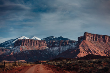 Fototapeta premium Snow Capped Peaks And Cloudy Skies In Moab Utah