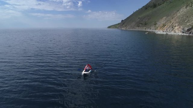 Canoe in the lake. Tourist canoeing on the Bay. Aerial drone shot.