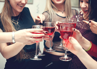 Cheers. Wine tasting event by happy people concept. Women toasting with glasses of red wine on party