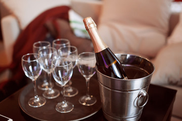 Cold chilled champagne in ice bucket with glasses