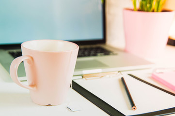 The layout template, laptop, office Desk with a tablet, a smartphone and a Cup of tea. Top view with copy space