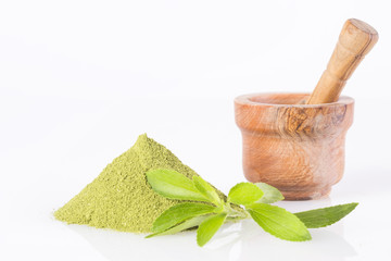 Natural sweetener in powder from stevia plant - Stevia rebaudiana. White background