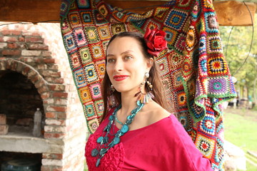  Beautiful gypsy woman in red with a red rose in her head