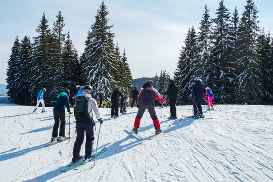 Winter holidays in the mountains. Mountain-skiing resort in the Carpathians.several skiers on a snowy road