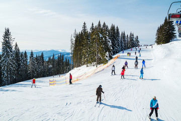Winter holidays in the mountains. Mountain-skiing resort in the Carpathians.several skiers on a...