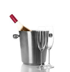 Bottle of rose champagne in bucket and glasses on white background