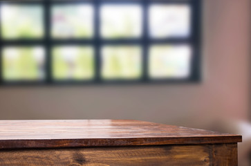 Wooden board empty table space platform in front of blurred Living Room Of The background - can be used for display or montage your products. Mock up for display of product