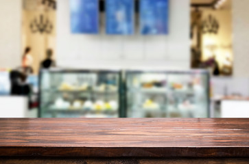 Selected focus empty brown wooden table and Coffee shop or restaurent blur background with bokeh image. for your photomontage or product display
