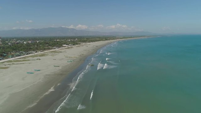 Aerial view of sandy beach Lingayen with fishermen using nets for fishing on the island Luzon, Philippines. Seascape, ocean and beautiful beach.