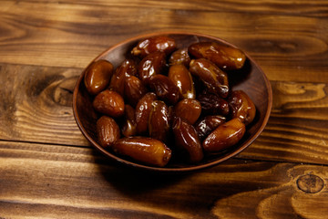 Dried dates fruit on wooden table
