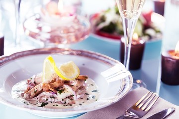 Close-up of Table with Food, Plates, Candles