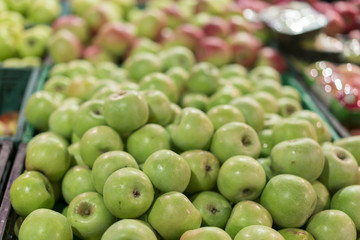 Green apples in a box in the store. green apples in boxes on market shelves. grocery shopping concept. healthy food.