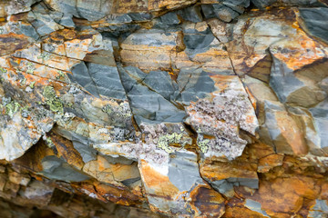 Background texture of a gray brown stone on the rock of the mountain discovered during archaeological excavations as a monument to millions of years of the formation of cancerous deposits under water
