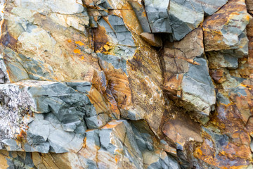 Background texture of a gray brown stone on the rock of the mountain discovered during archaeological excavations as a monument to millions of years of the formation of cancerous deposits under water