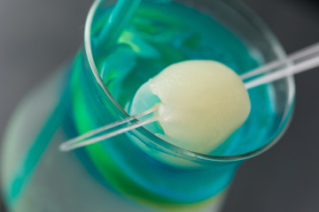 Electric iced tea garnished with lychee on a spear